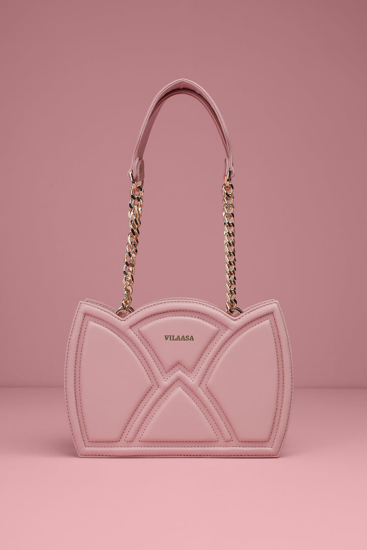 Pink Leather bag with chain detail on a pink background